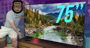 Televisor de tela grande ligado mostrando paisagem de rio e montanhas com o número 75 sobreposto
