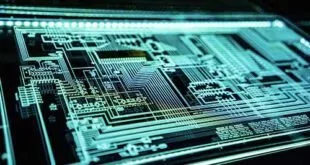 Placa de circuito eletrônico com trilhas iluminadas em tom azul, vista de perto