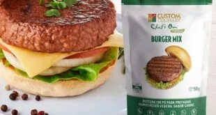Hambúrguer montado com alface ao lado de embalagem de mistura para hambúrguer vegetal