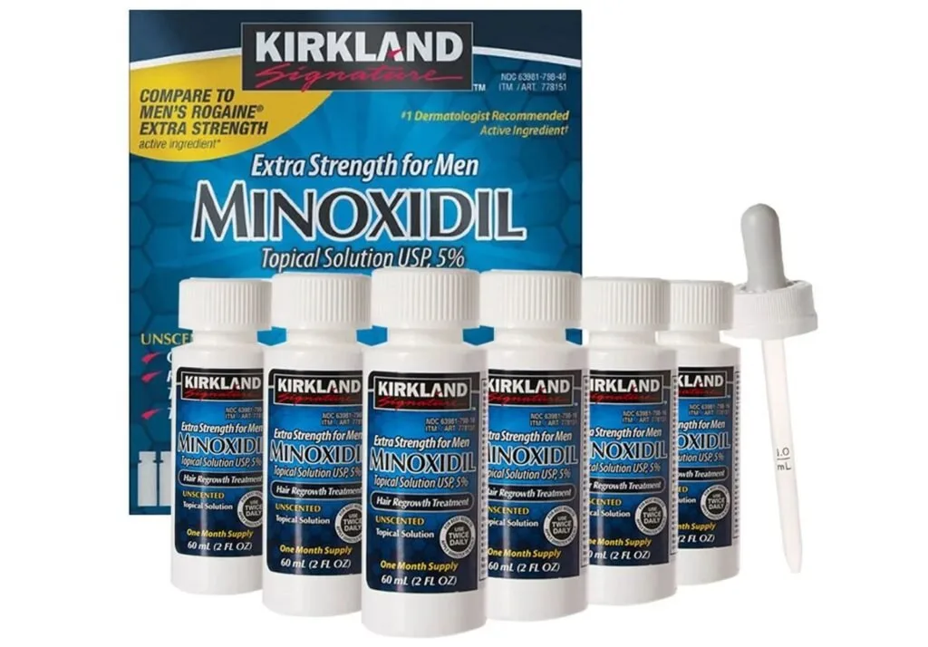 Frascos de minoxidil tópico a 5% da marca Kirkland ao lado da caixa e do conta-gotas