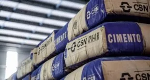 Sacos de cimento empilhados com a marca 'CSN' impressa na embalagem