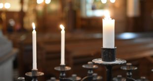 vela acesa sobre altar em igreja católica