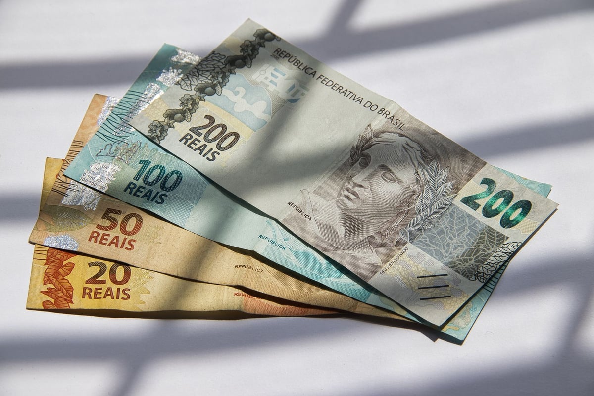 notas de dinheiro antigas e novas espalhadas lado a lado sobre uma mesa